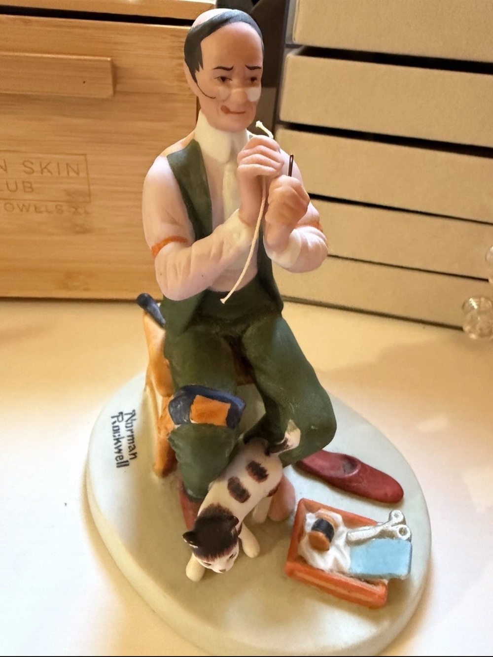 Porcelain Figurine Man Sewing with Cat - Green, White, Brown